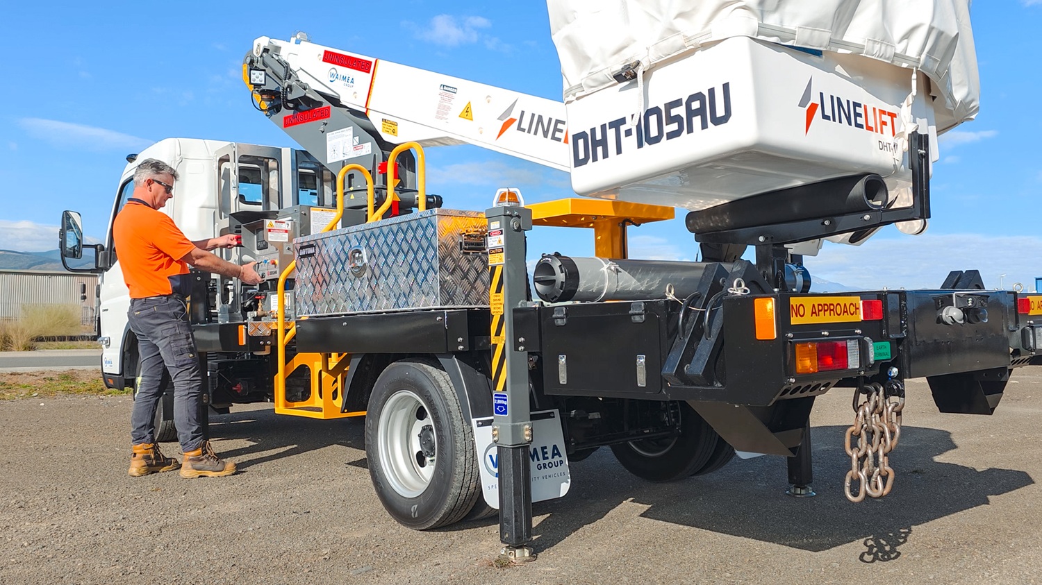 AU News Blog - The Ultimate Urban EWP Meet the Linelift® DHT105AU (3) A compact white EWP bucket truck with a boom and bucket mounted on the deck and outriggers on the sides, signwritten with Linelift® branding.