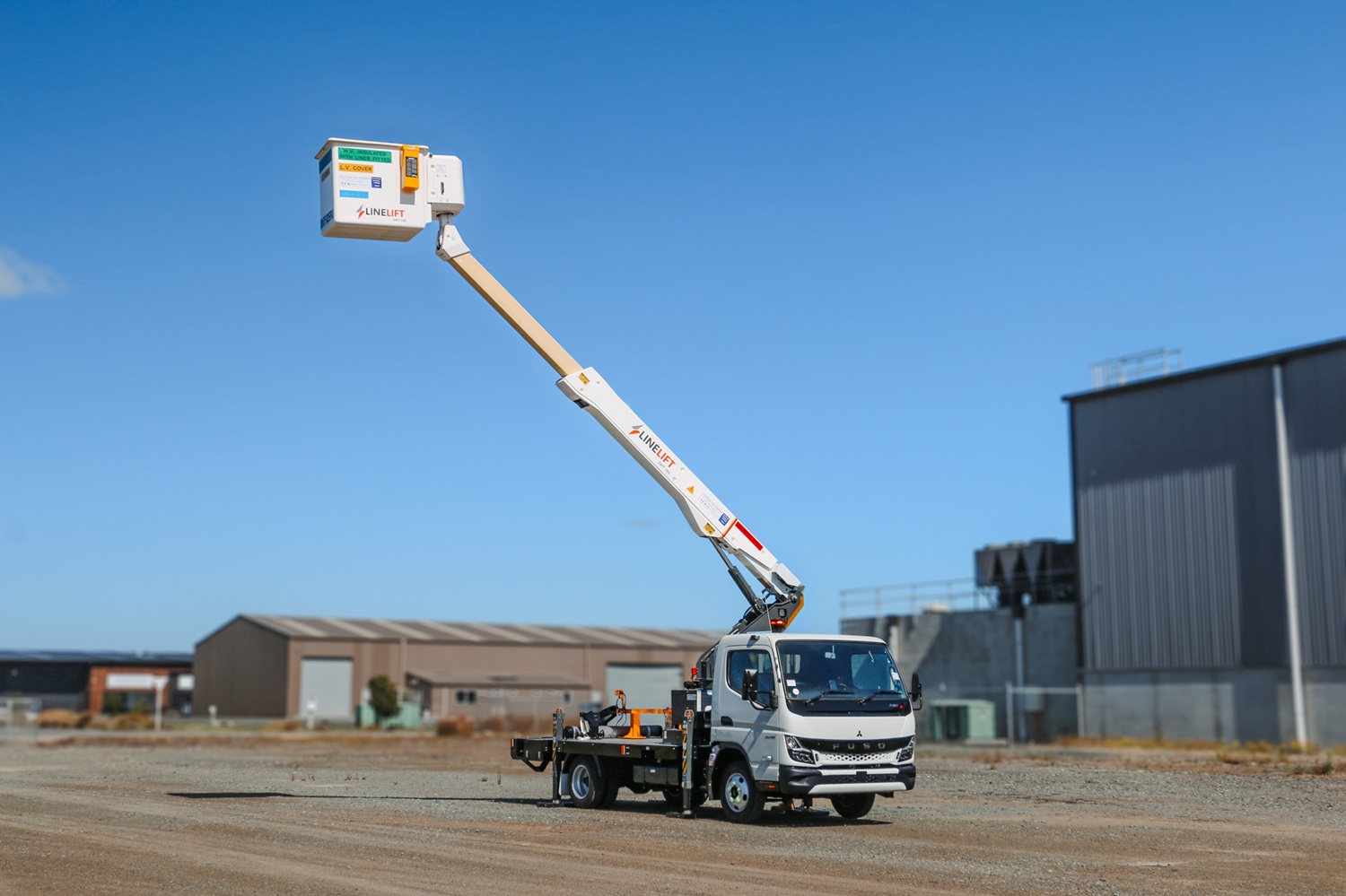 AU News Blog - The Ultimate Urban EWP Meet the Linelift® DHT105AU (5) A compact white EWP bucket truck with a boom and bucket mounted on the deck and outriggers on the sides, signwritten with Linelift® branding.