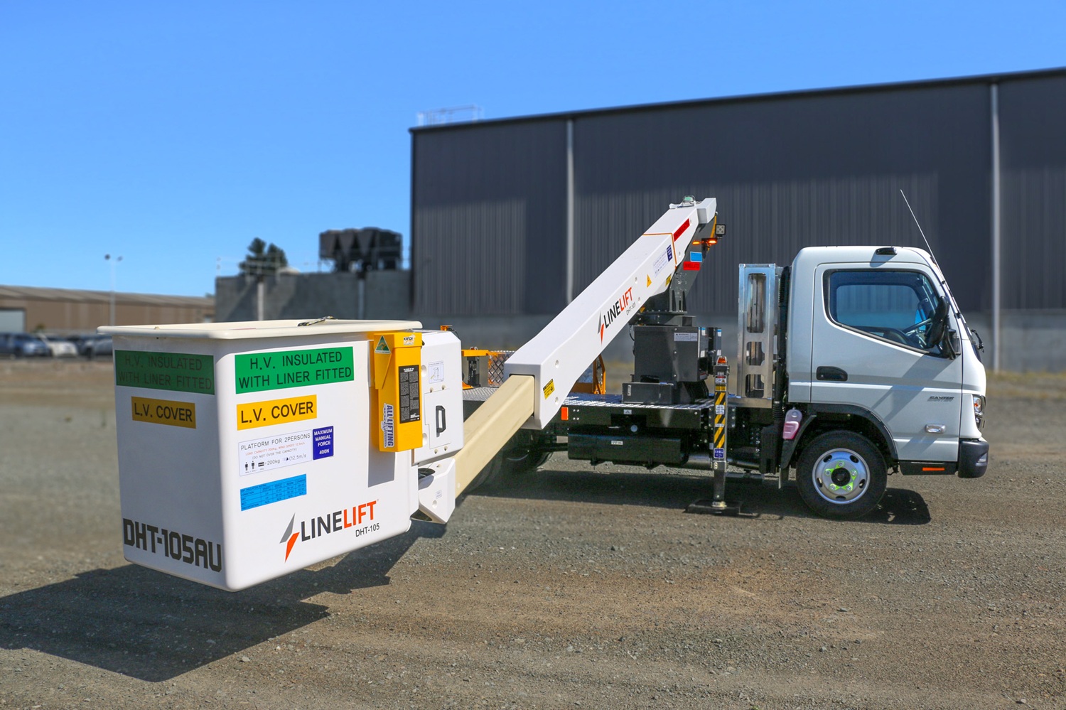 AU News Blog - The Ultimate Urban EWP Meet the Linelift® DHT105AU (6) A compact white EWP bucket truck with a boom and bucket mounted on the deck and outriggers on the sides, signwritten with Linelift® branding.