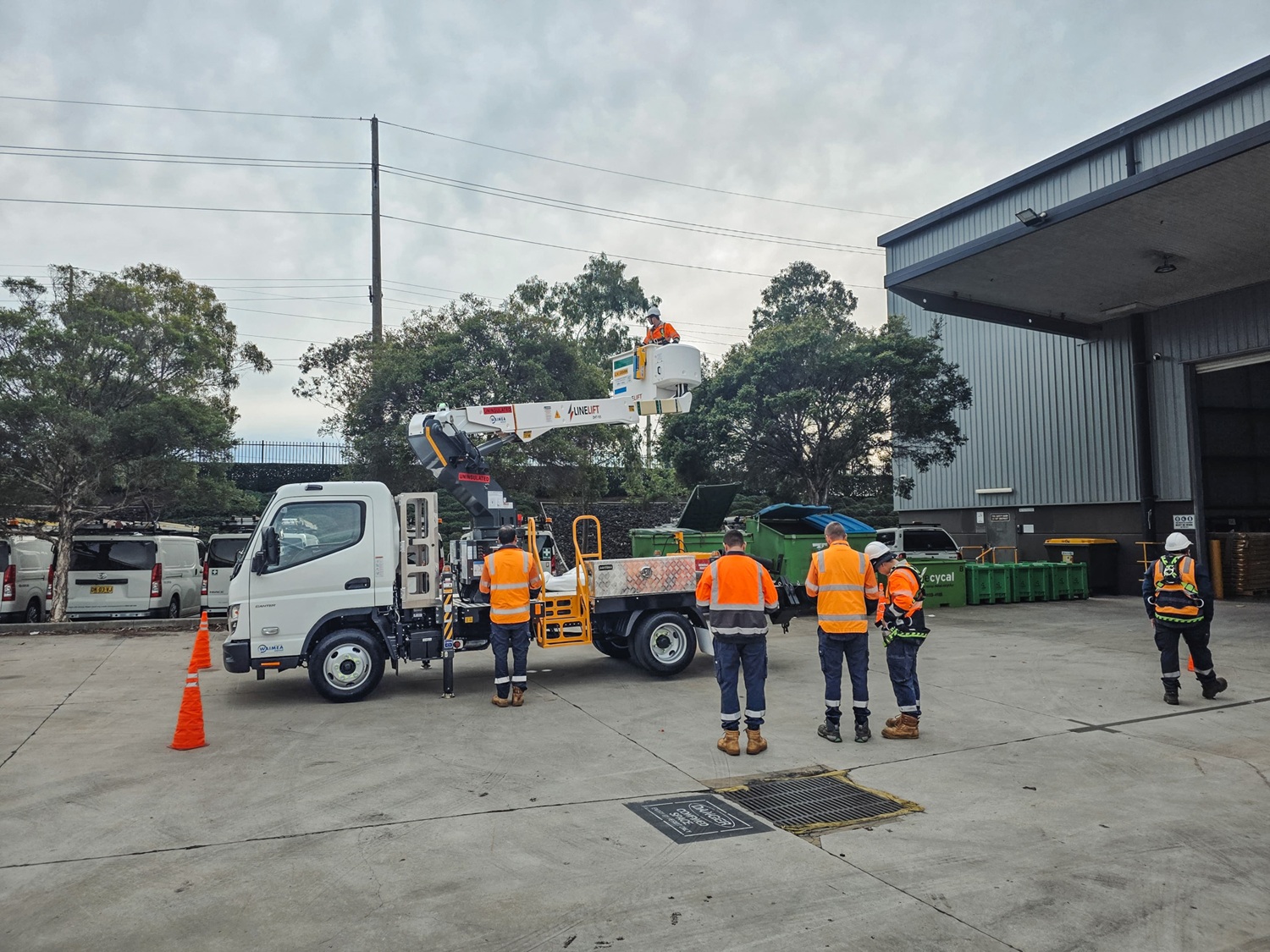 What Is Waimea's Rent to Own Option for Australian EWP Truck Buyers (1) A Waimea-supplied Linelift EWP truck parked on an Australian job site working on poles around trees.