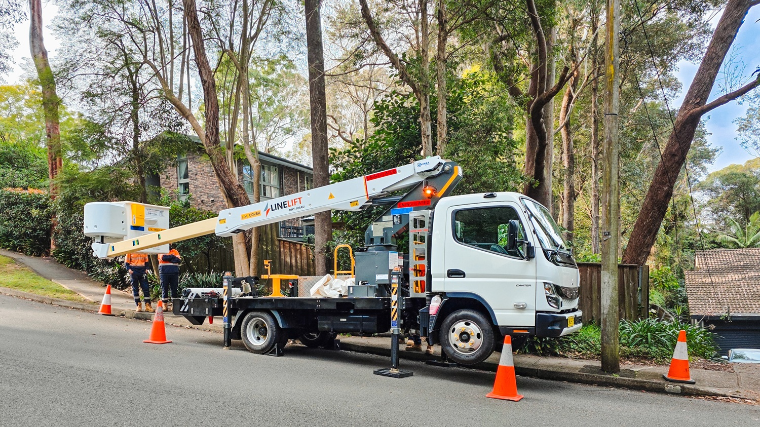 What Is Waimea's Rent to Own Option for Australian EWP Truck Buyers (2) A Waimea-supplied Linelift EWP truck parked on an Australian job site working on poles around trees.