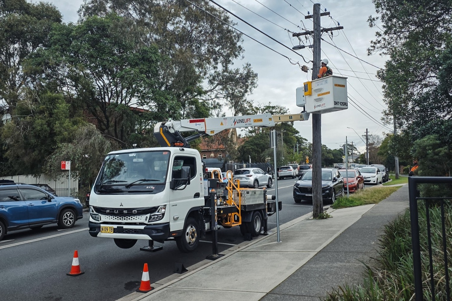 What Is Waimea's Rent to Own Option for Australian EWP Truck Buyers (4) A Waimea-supplied Linelift EWP truck parked on an Australian job site working on poles around trees.